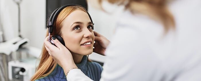 Patient looking up to health care provider during lenire follow-up appointment.